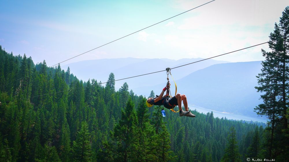 Exhilarating courses and breathtaking views are key components of any ziplining course. (Note: Photo features a KMZ employee. You do NOT need gloves to ride the ziplines.)<br>